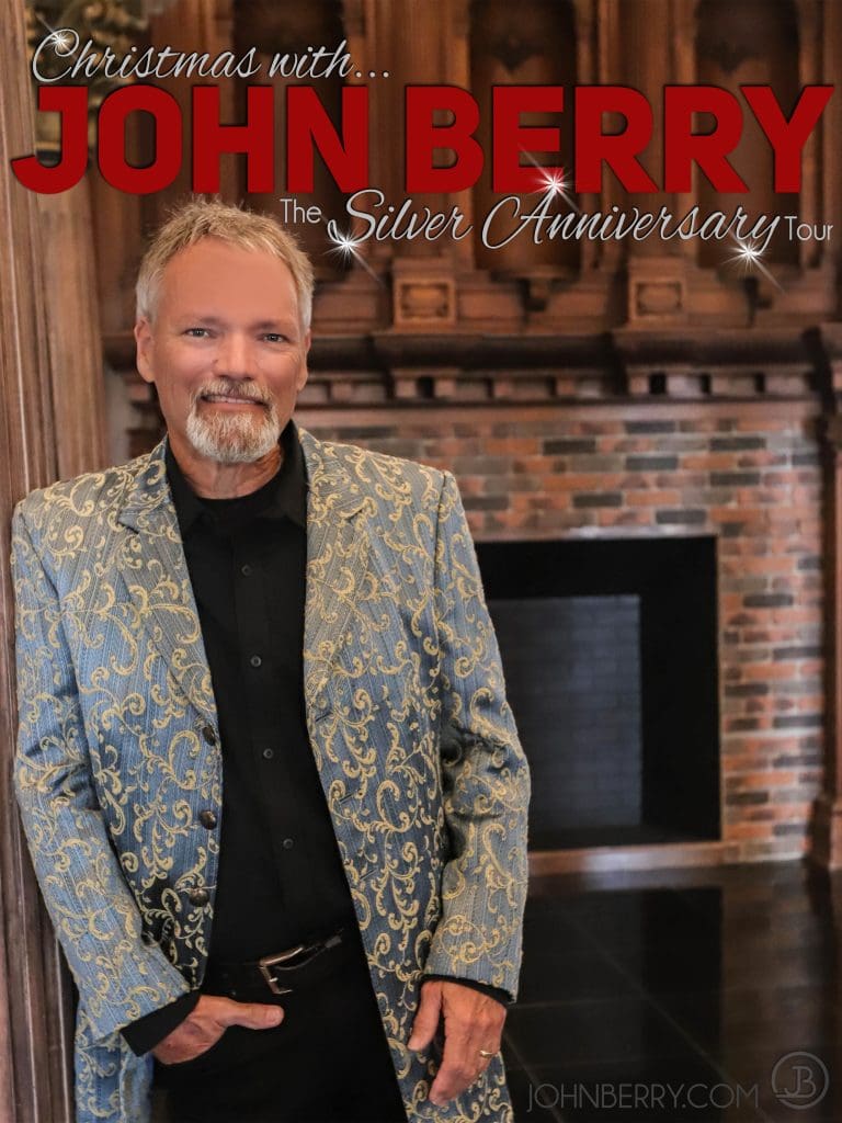 A man in a suit standing next to a fireplace.