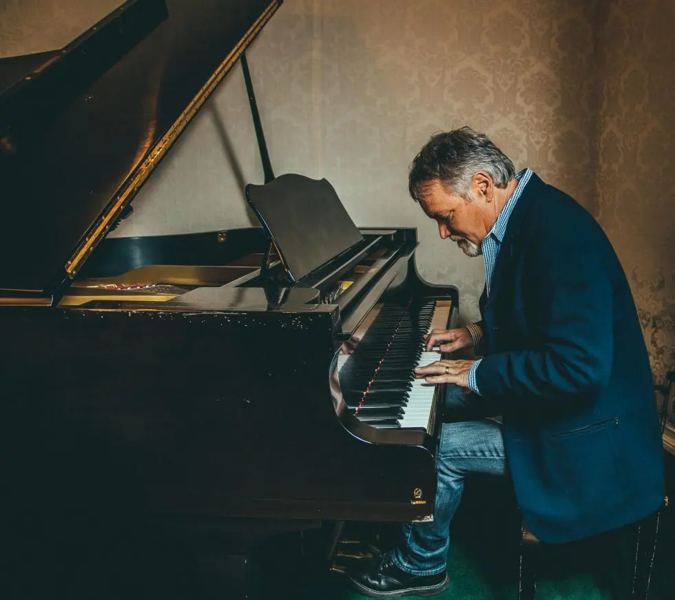 A man sitting at the piano playing something