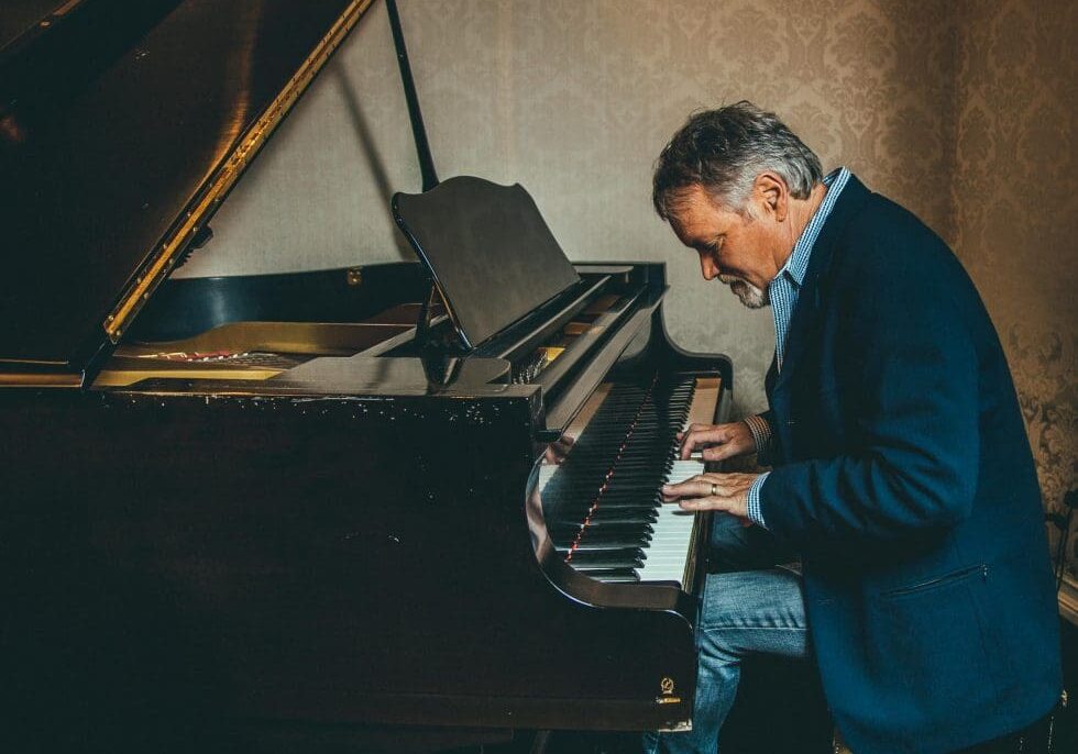 A man sitting at the piano playing something