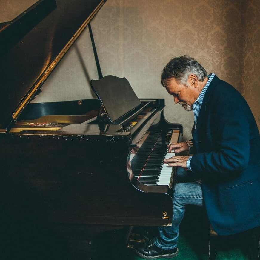 A man sitting at the piano playing something